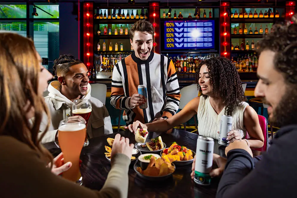 Eating and drinking at a table in Puttshack