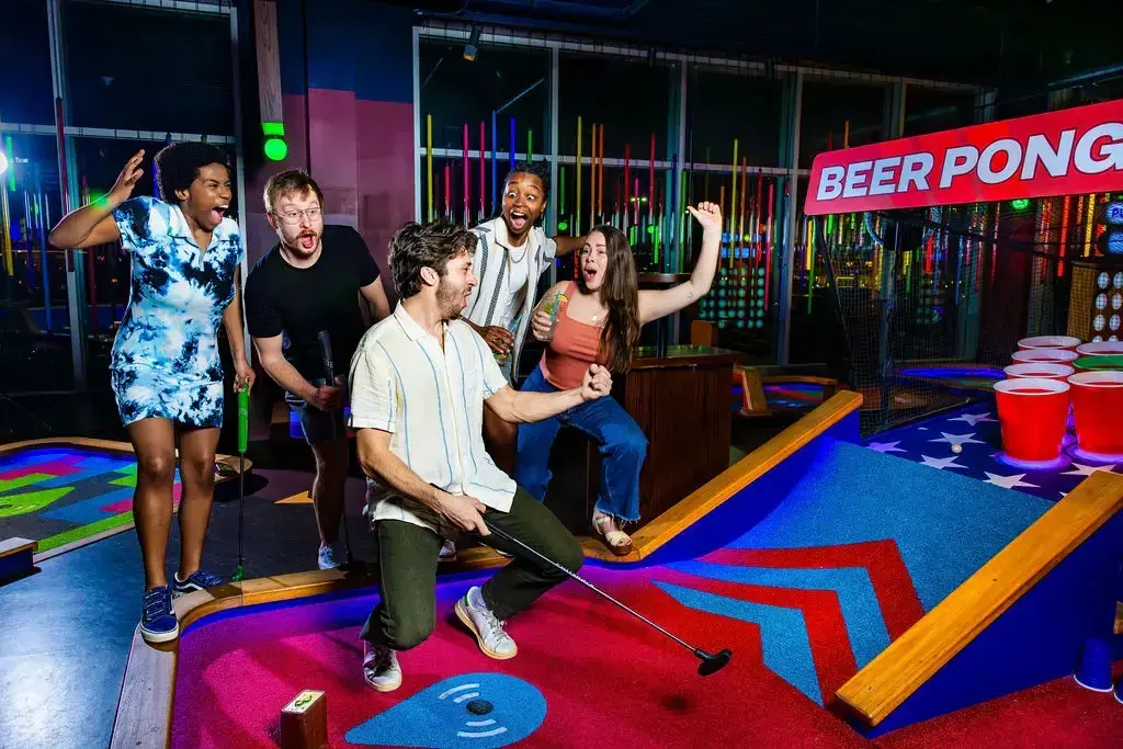 people excited by the beer pong hole