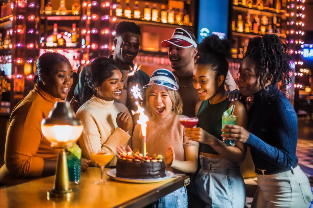 A group of friends celebrating with a cake