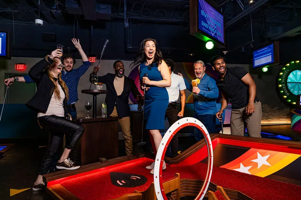 A group of adults celebrating on a course