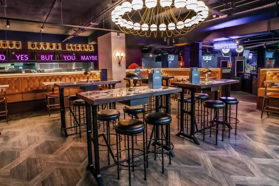Image of a Puttshack venue's high tops at Watford