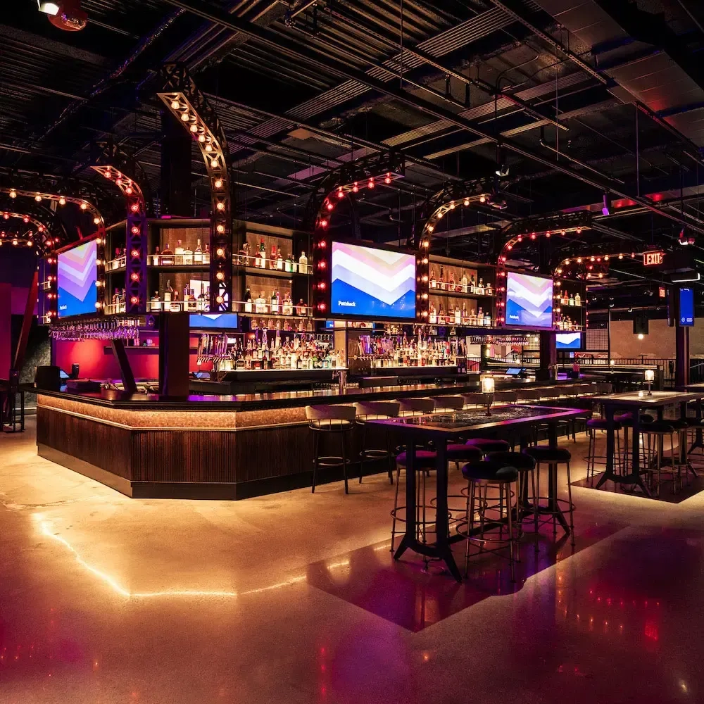 puttshack bar and tables with tvs