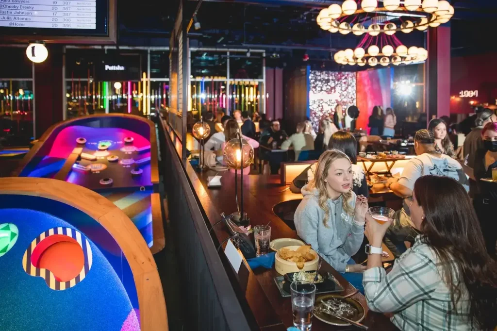 image of two holes and people enjoying food and drinks