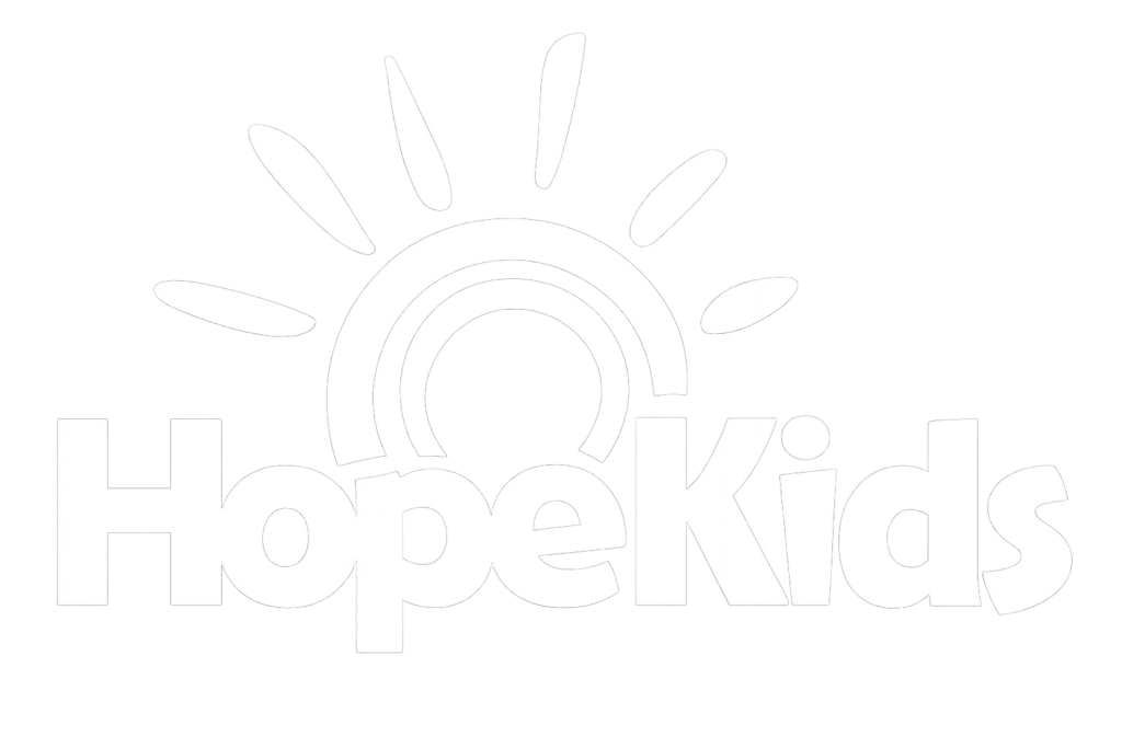 A light-toned logo displaying the text “HopeKids” with a stylized rainbow and sunburst icon above the lettering on a white background